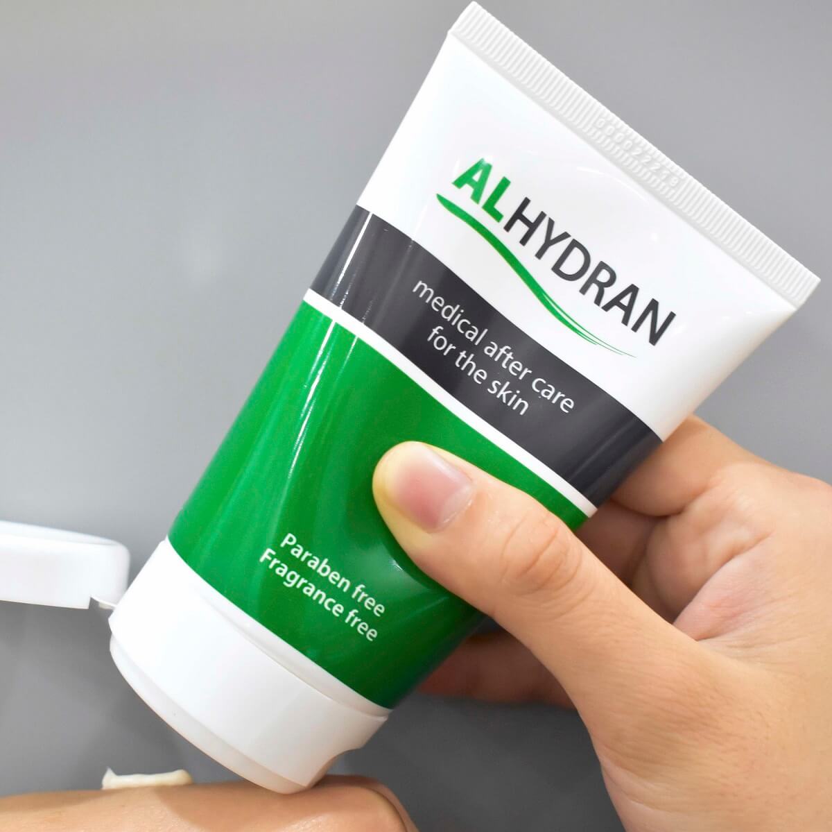 Person applying Alhydran scar cream to hand for car removal