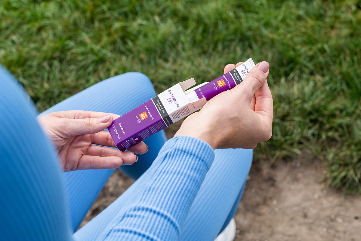 Person opening a Bapscar SPF40 silicone scar therapy