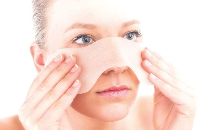 Scarban silicone sheet in place on nose for targeted scar therapy and UV protection